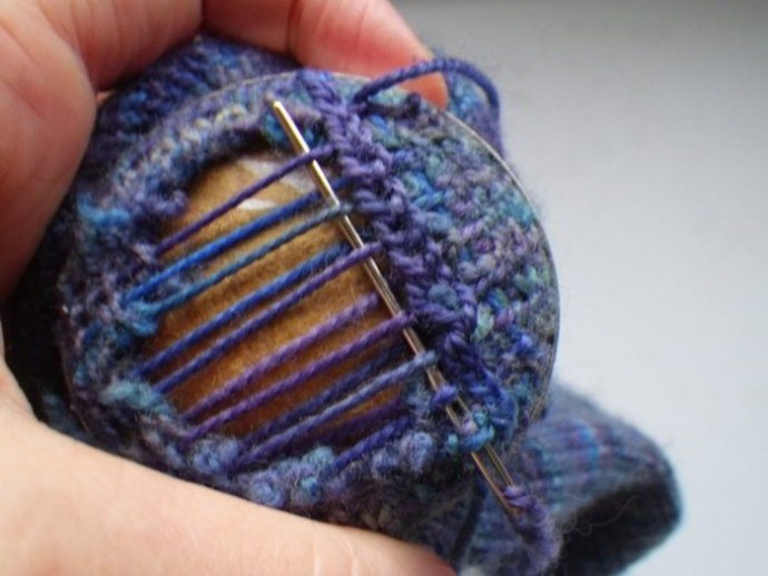 Using a darning mushroom to weave in ends